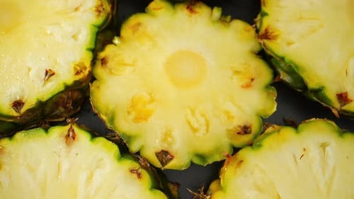 Macro video, a juicy pineapple slice takes center stage