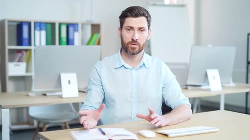 Office worker, Man employee coach or teacher speaks look at camera. Webcam view Sitting at work