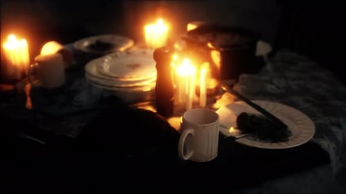 Candlelit Dining Table with Plates and Mugs