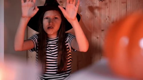 Girl in Witch Hat Casting Halloween Spell