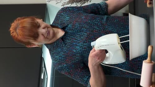 Woman Uses Electric Mixer in Modern Kitchen