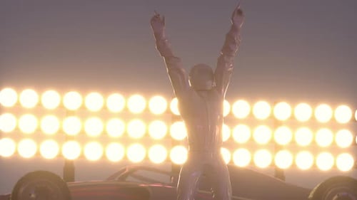 Silhouette of race car driver celebrating his victory in the race against bright lights