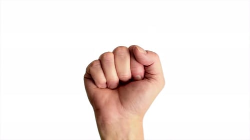 Close up shot of a male hand holding up a classic power or fist sign, against a plain white backgrou