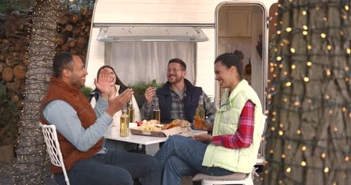 Young Friends Having a Picnic in Autumn Woods