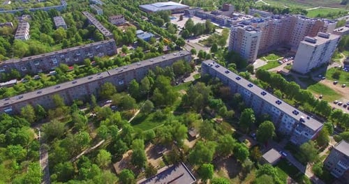 Long blocks of flats in the residential area. Green quarters with multi-storied buildings