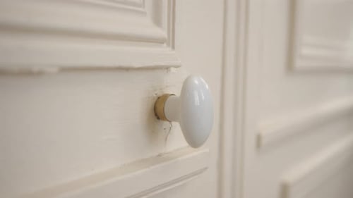 Scary and Creepy white door moving in a haunted house, close up