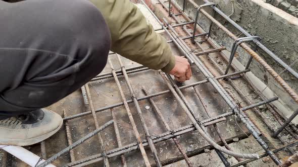 12-01-24; Workers attach steel rods to make RCC columns as per site ...