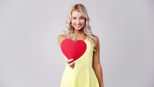 Smiling Woman Holding Red Heart