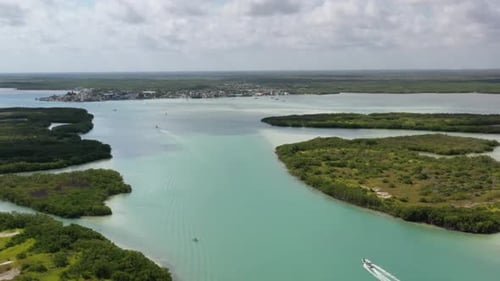 Drone footage of boat cruising in Caribbean tropical sand beach with turquoise - sapphire water, Rio