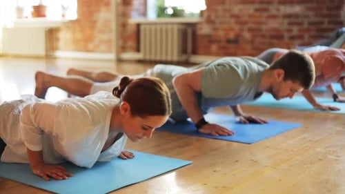 Yoga Class Practicing the Downward Dog Pose