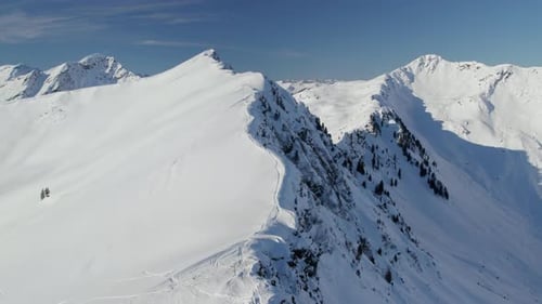 Snowy Mountain Reiterkogel With Steep Ridge In Saalbach- Hinterglemm, Austria. aerial shot