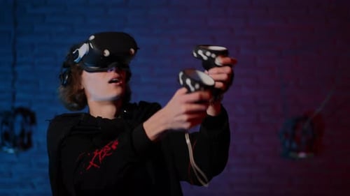 Enthusiastic Young Adult Immersed in Virtual Reality Gaming