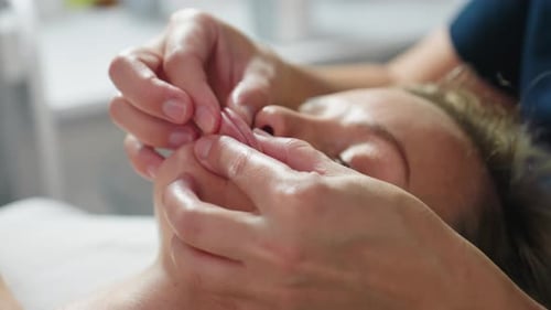 Woman Receives Relaxing Facial Massage at Spa