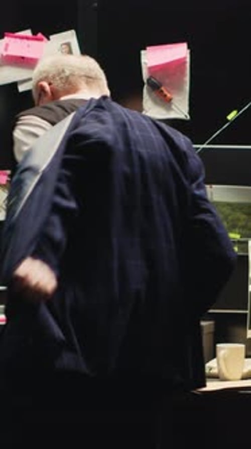 Man Stands Near Investigation Detective's Board