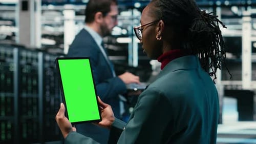 Isolated Screen Mockup Tablet Writing Code and Developer in Data Center