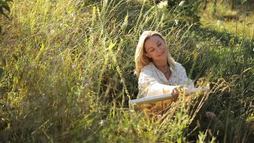 Woman Relaxing in a Sunny Meadow
