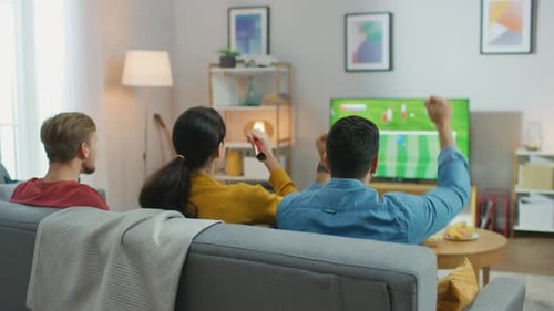 Friends watch sports, react to game at home