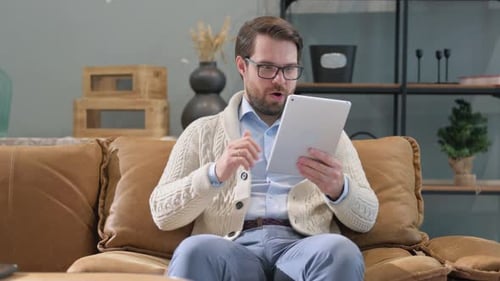 Man Uses Tablet and Reacts Positively