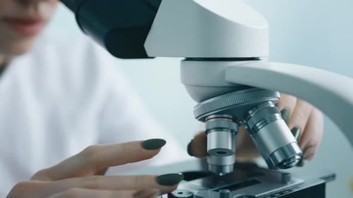 Scientist Uses Microscope in Modern Laboratory