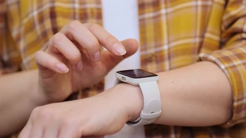 Adult Hand Tapping Smartwatch Touchscreen Close Up