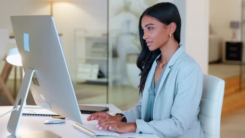 Young Woman Working at a Desk in Office