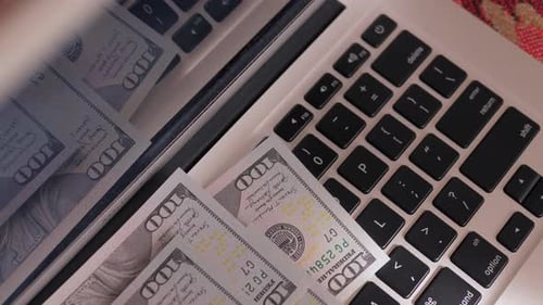 Laptop Keyboard Covered with US Dollar Bills