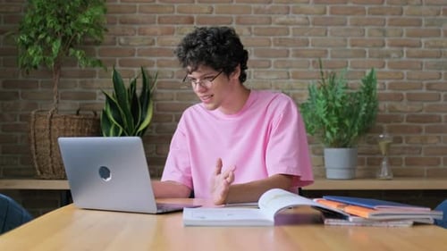 Young Adult Video Conferencing at Desk