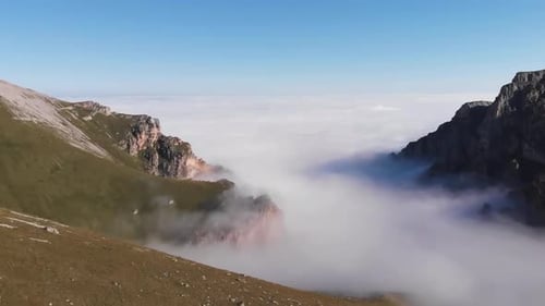 Aerial View of Mountains Above a Cloudy Valley