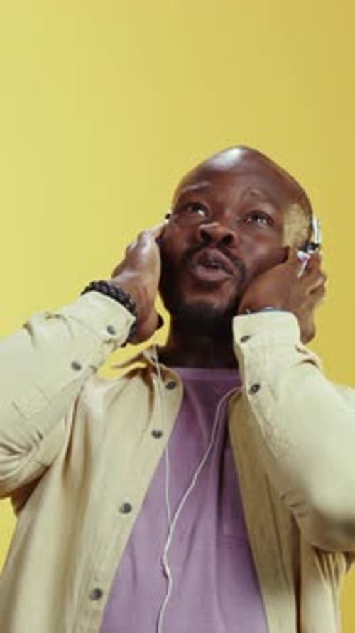 Man enthusiastically listening to music on headphones