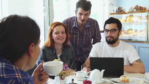 Friends Chatting Together at a Cafe