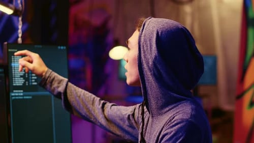 Hooded Hacker Coding Malware