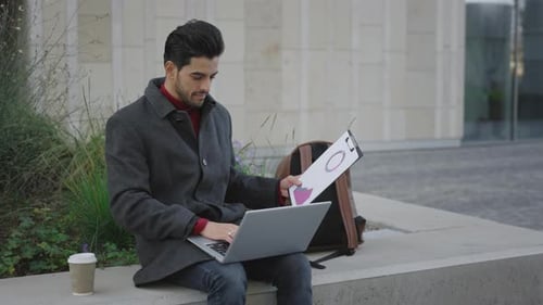 Handsome Bearded Multiethnic Man Sitting Working On Laptop Outside Foreigh Student Studying In the