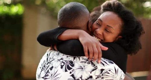 Happy Woman Embracing Man Outside on Sunny Day