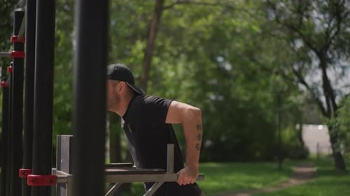 Individual Engaged In Triceps Exercises Amidst Green Surroundings Person Executing Triceps Dips In
