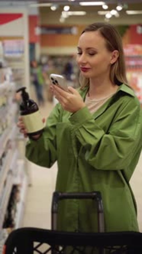 Woman Scanning Product Barcode with Smartphone in Store