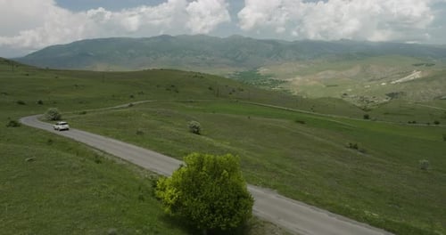 White SUV Vehicle Driving On Country Road Near Aspindza In Georgia. aerial