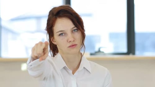 Pointing Toward Camera Woman in Office