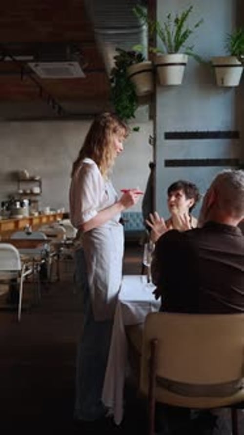 In A Restaurant, A Waiter Takes An Order From A Young Couple In An Elite Restaurant.