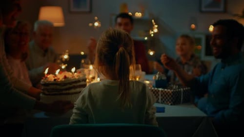 Back View Shot: Birthday Celebration of Cute Little Girl at the Dinner Table, Mother Brings Cake an