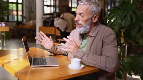 Mature Adult on Video Call with Laptop