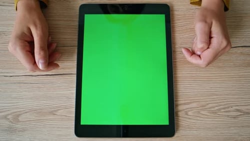 Hands Interacting with Tablet Green Screen on Desk