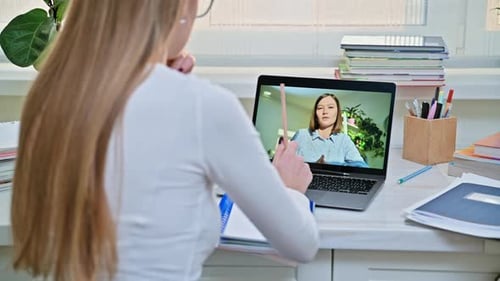 Woman Attends Online Lesson on Laptop at Desk