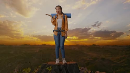 Full Body Of Asian Female Hiker Smiling And Pointing To Side On The Top Of Mountain