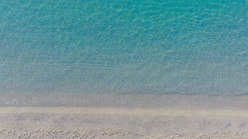 Gentle Waves on a Tropical Beach Shoreline