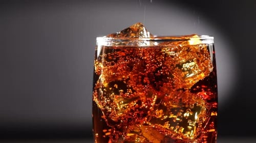 Refreshing Soda with Ice Filling Clear Glass