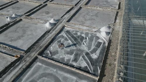 Workers Rake and Harvest Salt at Salt Farm
