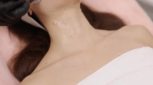 Woman Receiving Facial Treatment at Clinic