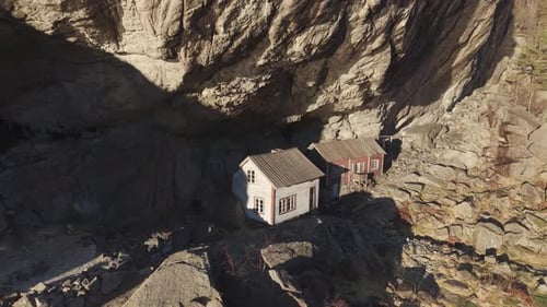 Helleren - historical site with two old houses under cliff. Norway, drone footage