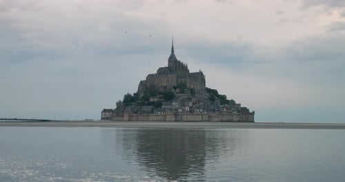 Rocky Island With Mont Saint Michel And Monastery In Normandy, France. Wide Angle