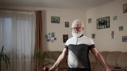 Senior Man Lifting Dumbbells for Exercise at Home